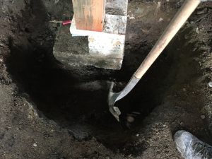 Shovelling a hole for repair