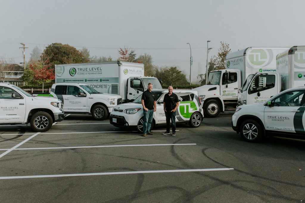 True Level staff with company service trucks