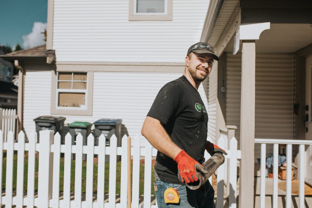 Employee holding a metal tube smiling