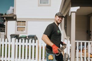 Employee holding a metal tube smiling