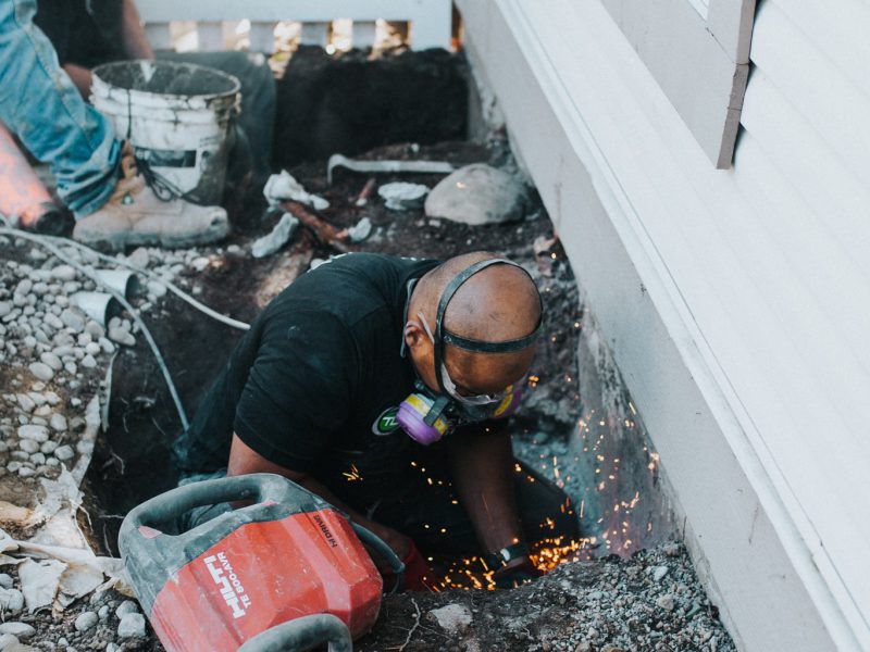 Employee wearing a protective mask during repair