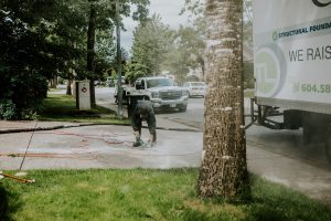 Staff bending down to fix the concrete