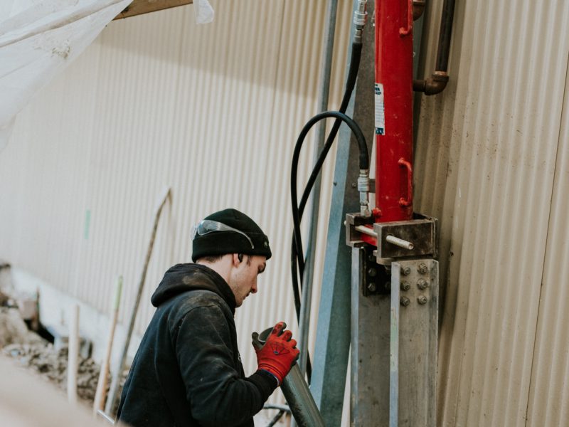 Employee holding large metal tubes