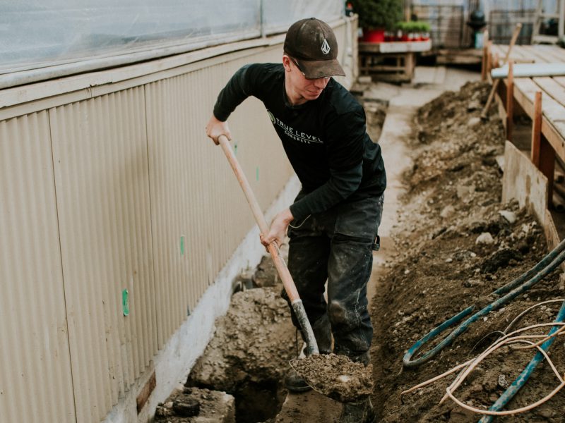 Employee using a shovel for foundation repair