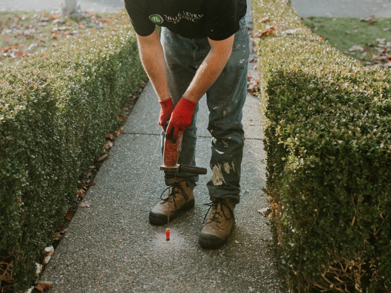 True Level employee with a slabjacking and crack repair tool