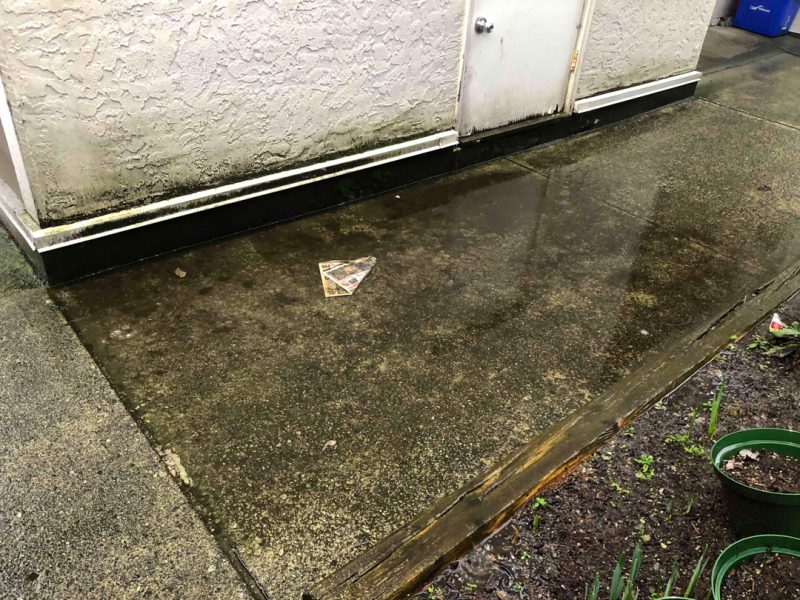 Side view of pooling water against house - Pooling Water - True Level Concrete