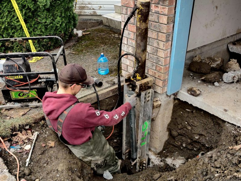 Man fixing foundation side view - Chilliwack Sunken Foundation - True Level Concrete