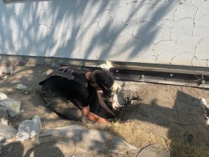 crew digging a hole near the foundation