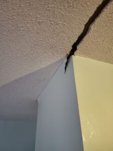 Crack in ceiling and drywall - symptoms of settlement in Richmond home