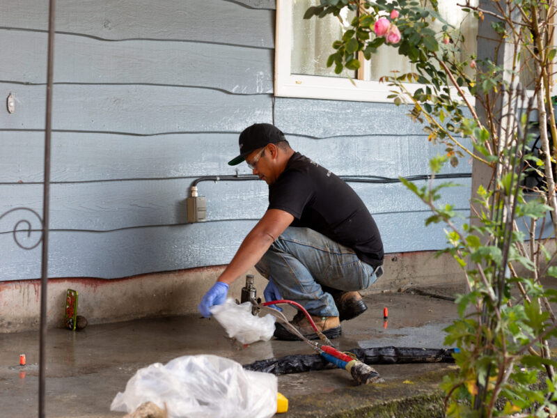 Installer putting polylevel under concrete slab