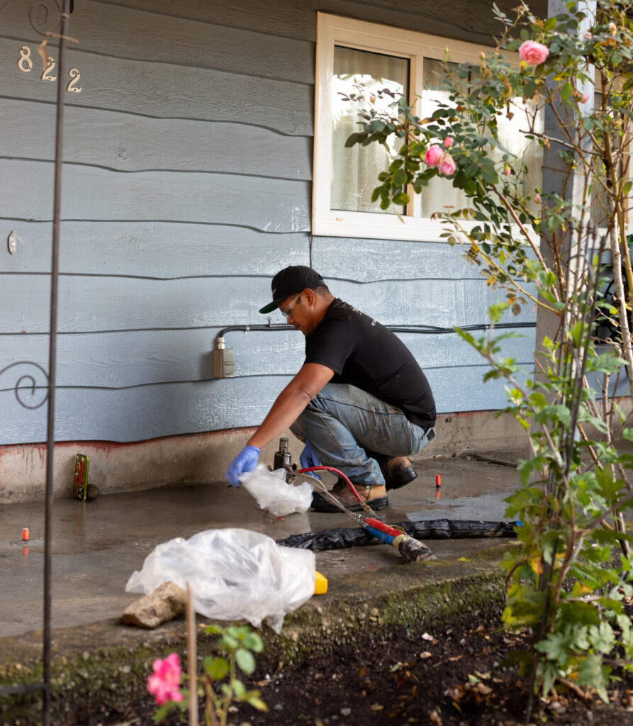 Installer putting polylevel under concrete slab