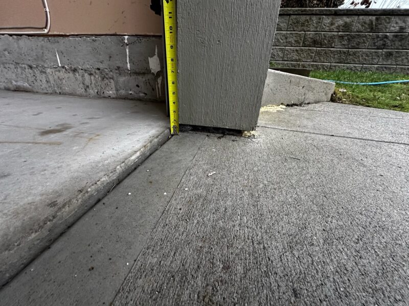 Before: Driveway slab sunken leaving gaps under the garage door