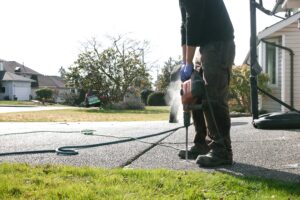 Installer drilling into driveway