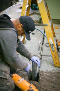 crew lead installing piers int he ground