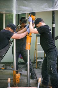 Post pounding steel piers through concrete