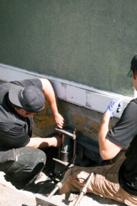 crew using piers to lift and level a home