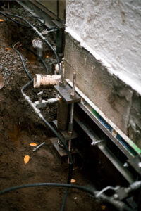 bracket on home foundation push pier