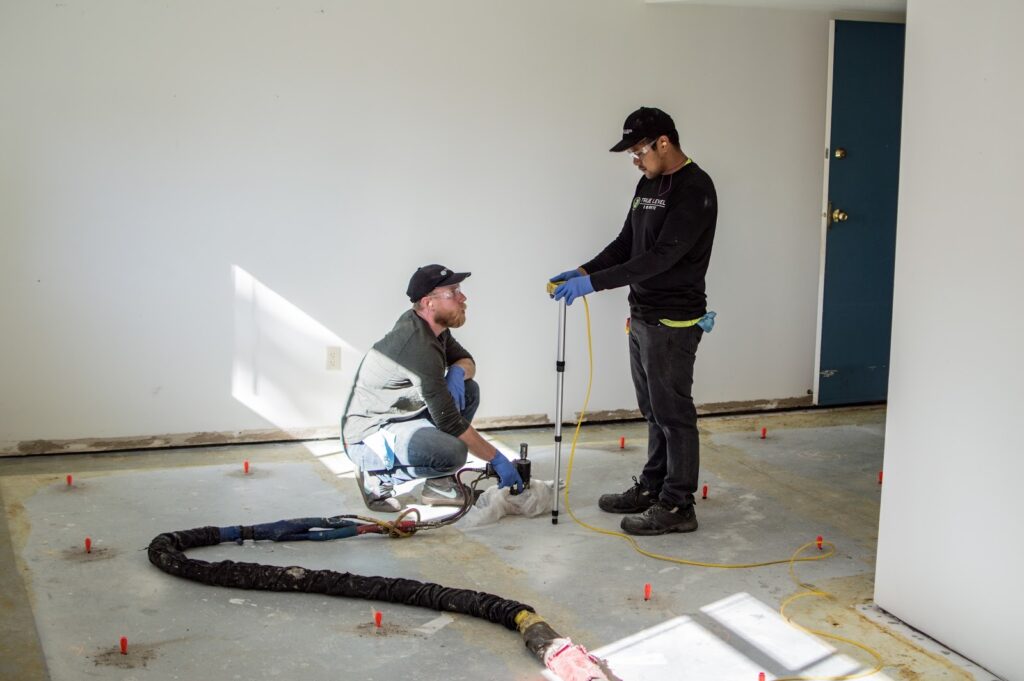rue Level Concrete technicians performing concrete leveling on indoor job site